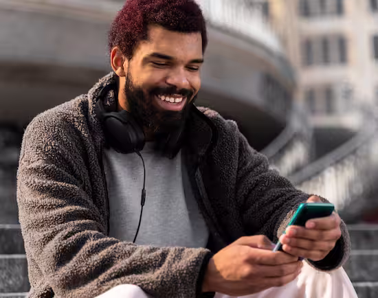 Men that smile looking at his smartphone